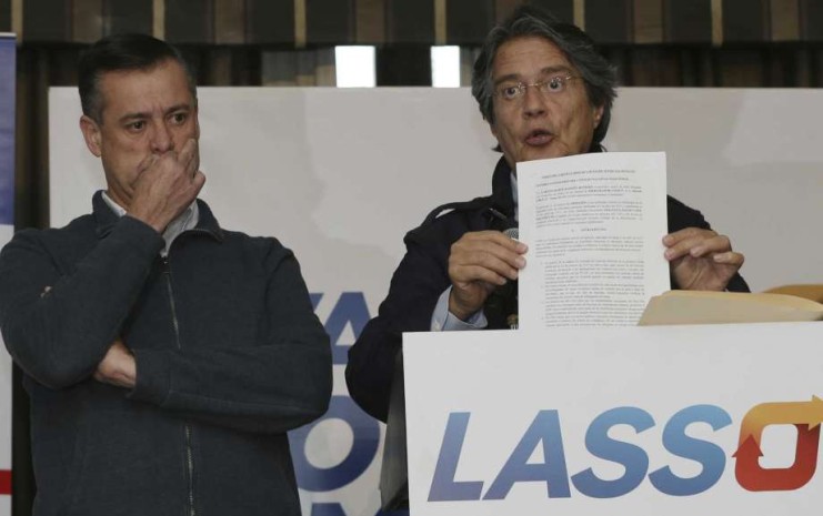 Guillermo Lasso, the opposition candidate defeated in the elections of April 2, shows a document during a press conference at Dan Carlton hotel in Quito, Ecuador, Wednesday, April 12, 2017.