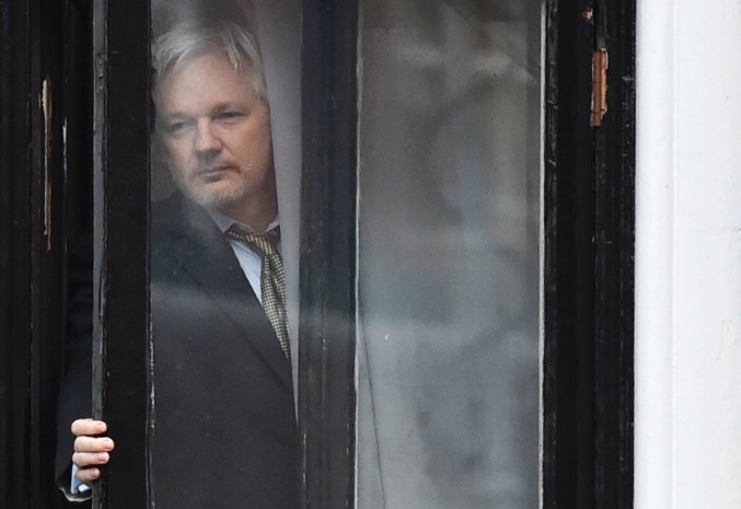 WikiLeaks founder Julian Assange steps out on the balcony of the Ecuadoran Embassy to address the media in London in February. (Ben Stansall/AFP via Getty Images)